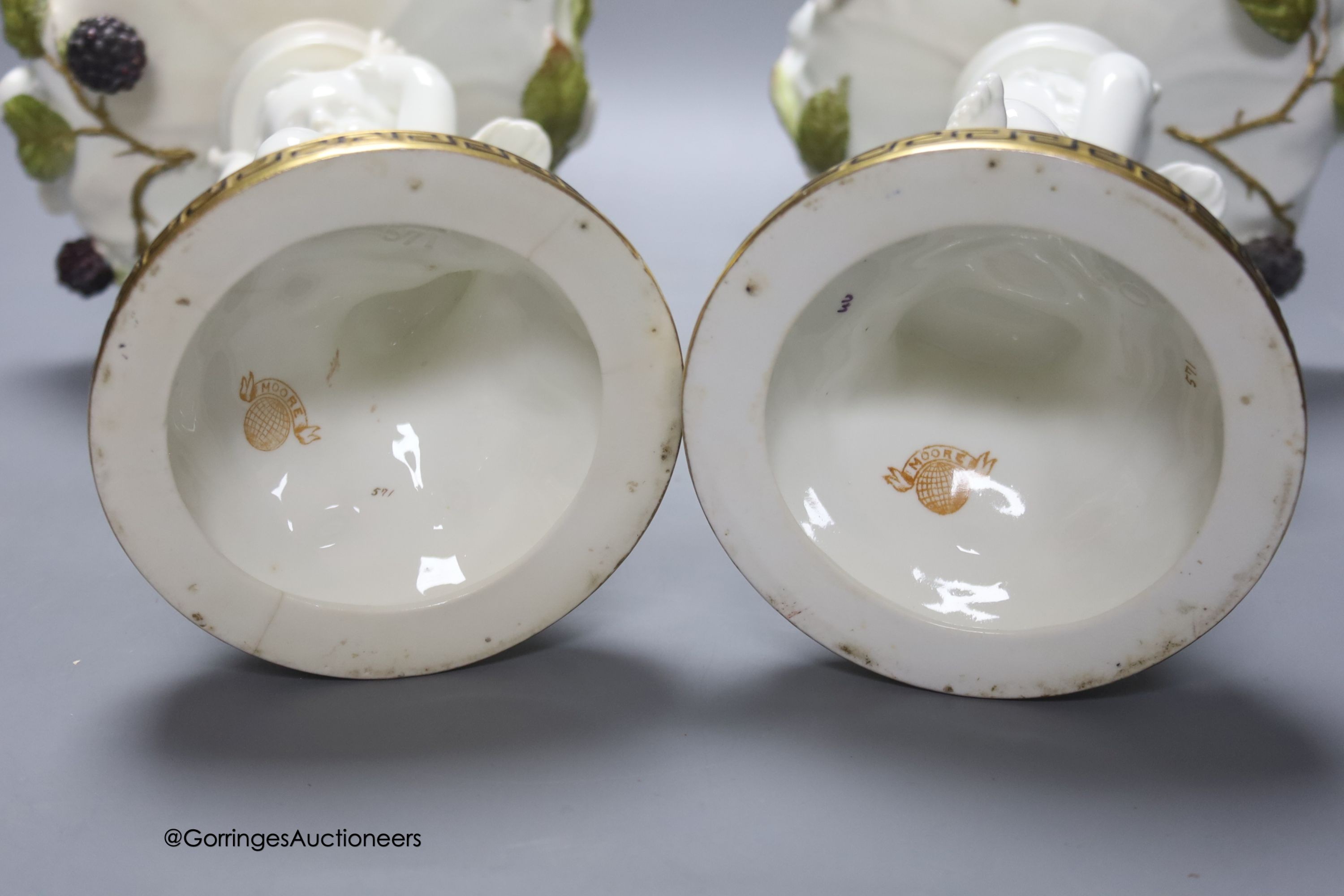 A pair of Moore Bros leaf pattern bowls, encrusted with fruit and surmounted by cherubs and a similar pair of tazza stands, height 24cm